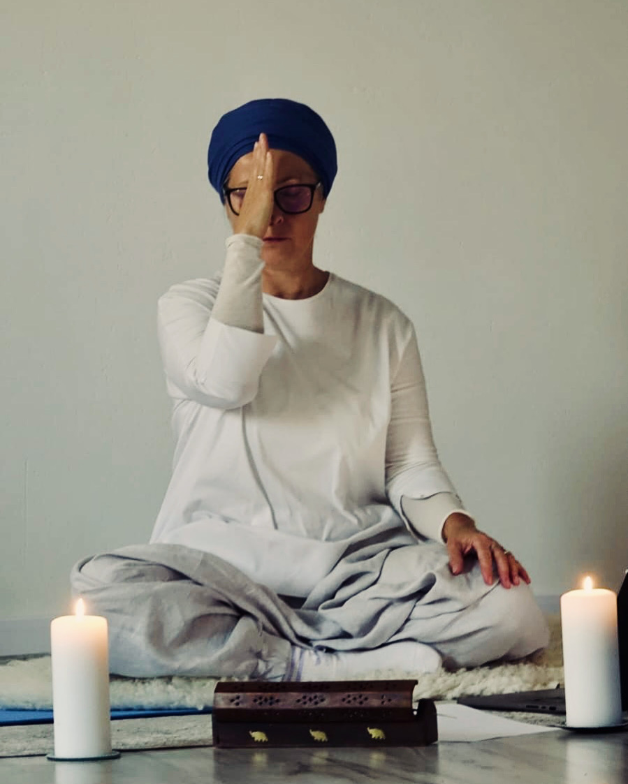 Linda practising Kundalini Yoga breath and concentration by candlelight
